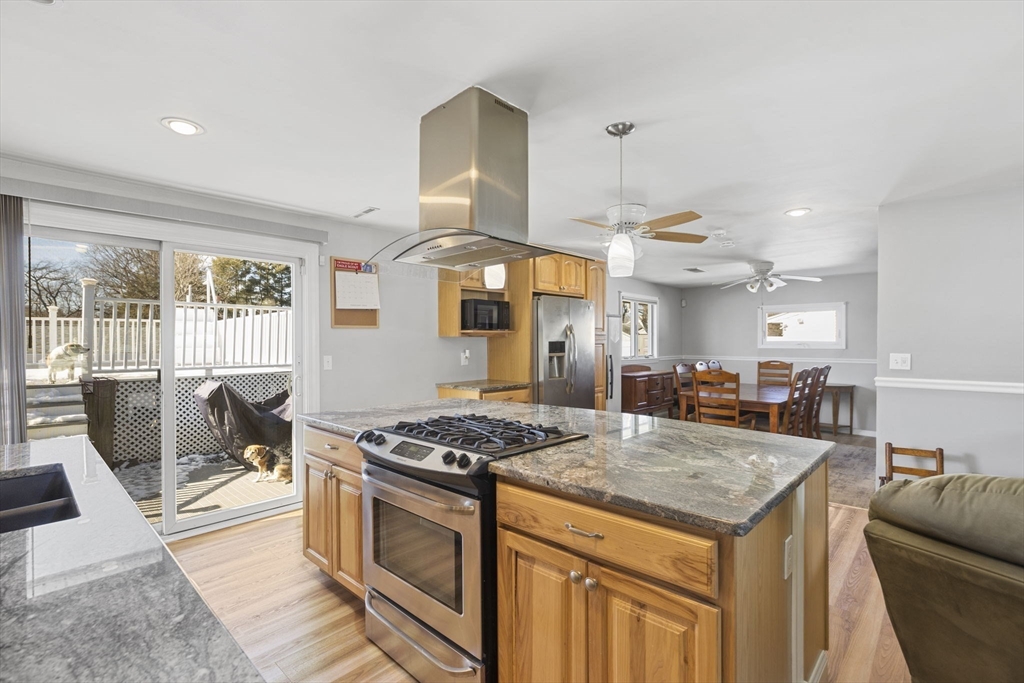 134 Deanna Road Brockton, MA 02302 - Photo 10 of 33 a kitchen with granite countertop a stove a sink a refrigerator and wooden floor