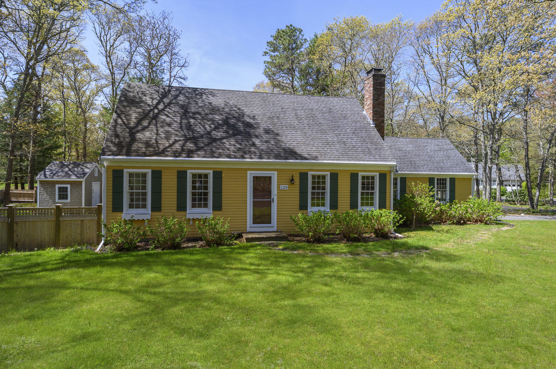 129 Richardson Road Centerville, MA 02632 - Photo 1 of 24 a view of a house with a yard and sitting area