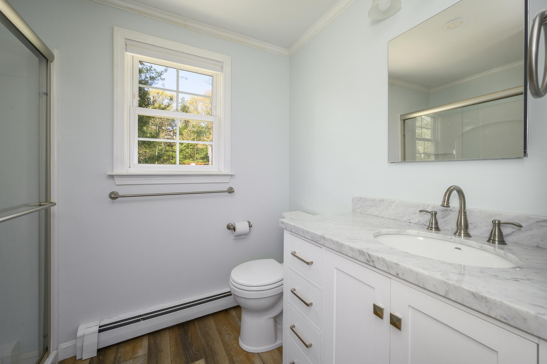 129 Richardson Road Centerville, MA 02632 - Photo 11 of 24 a bathroom with a granite countertop toilet a sink and a mirror