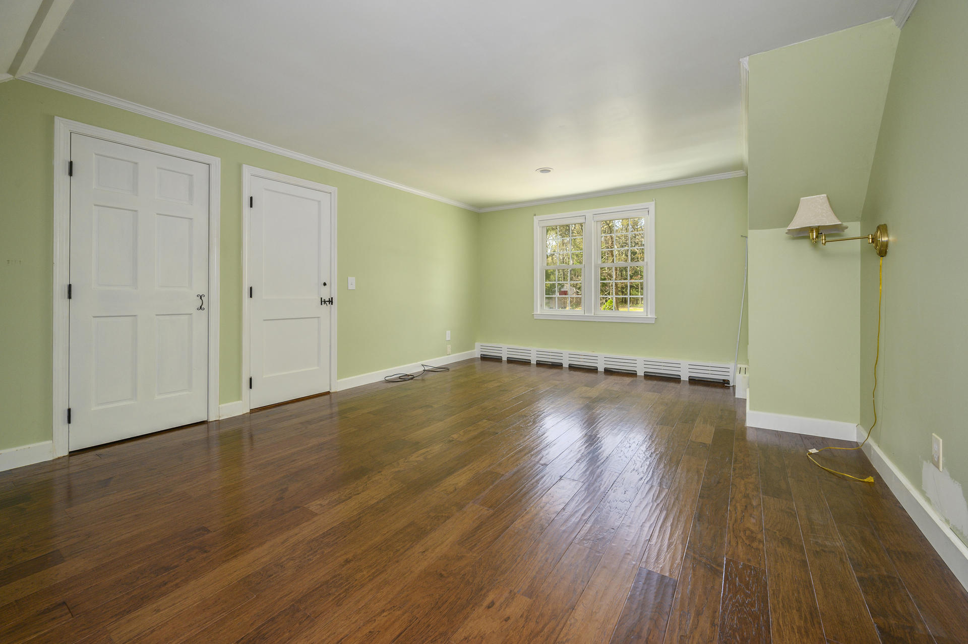129 Richardson Road Centerville, MA 02632 - Photo 12 of 24 an empty room with wooden floor and windows