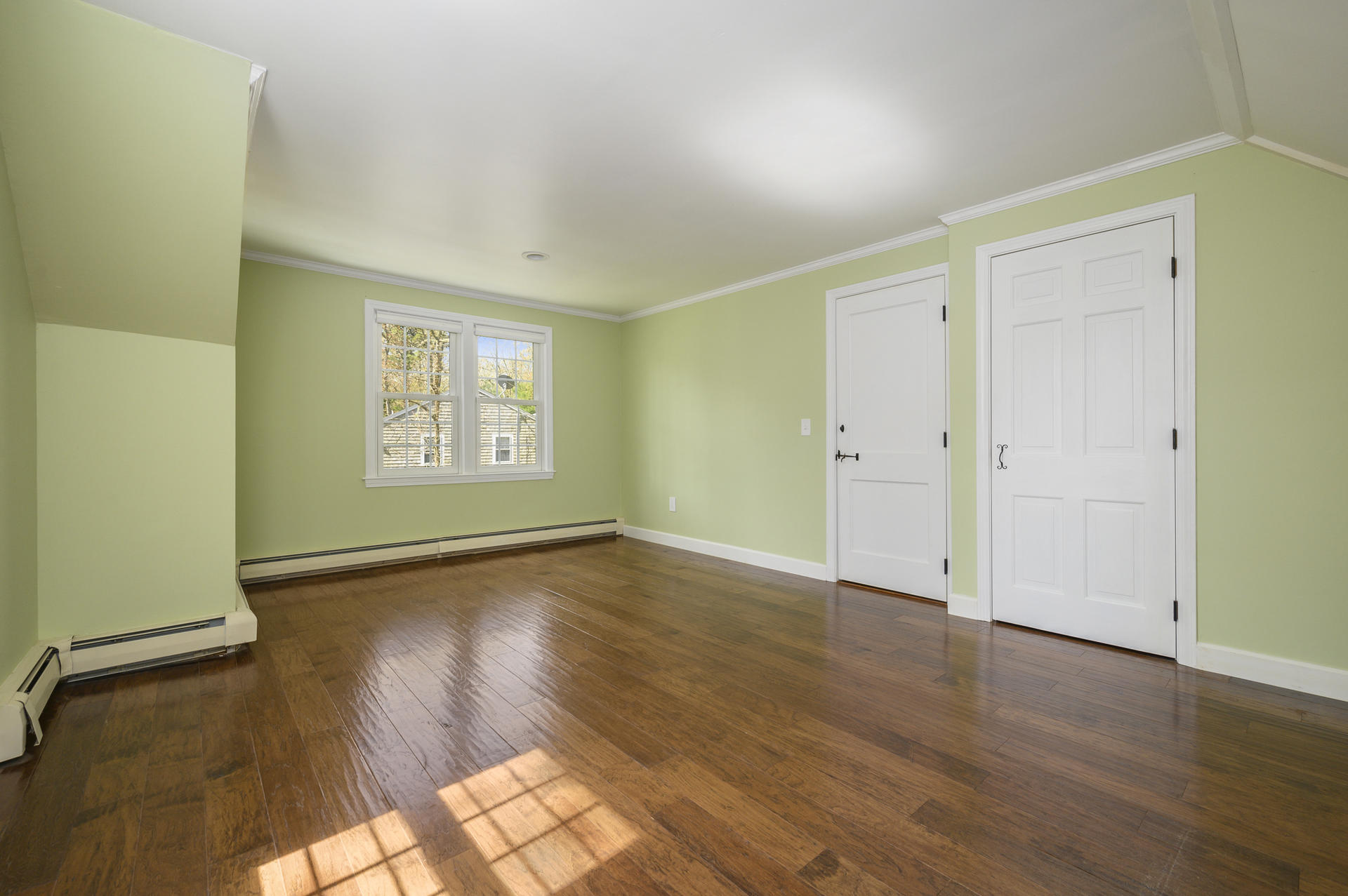 129 Richardson Road Centerville, MA 02632 - Photo 14 of 24 an empty room with wooden floor and windows