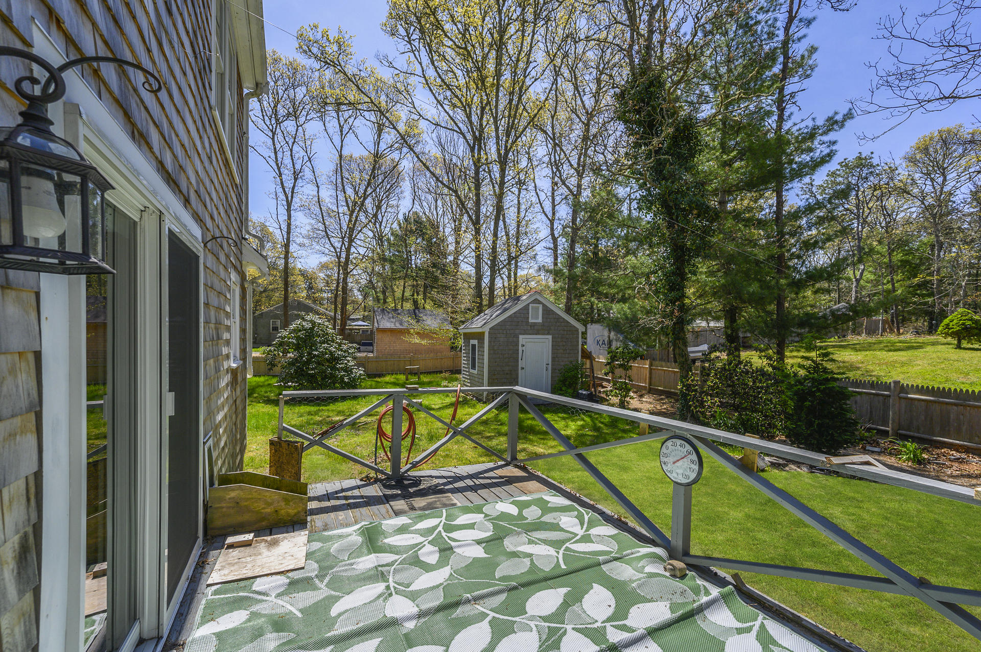 129 Richardson Road Centerville, MA 02632 - Photo 16 of 24 a view of a swimming pool with a garden and trees