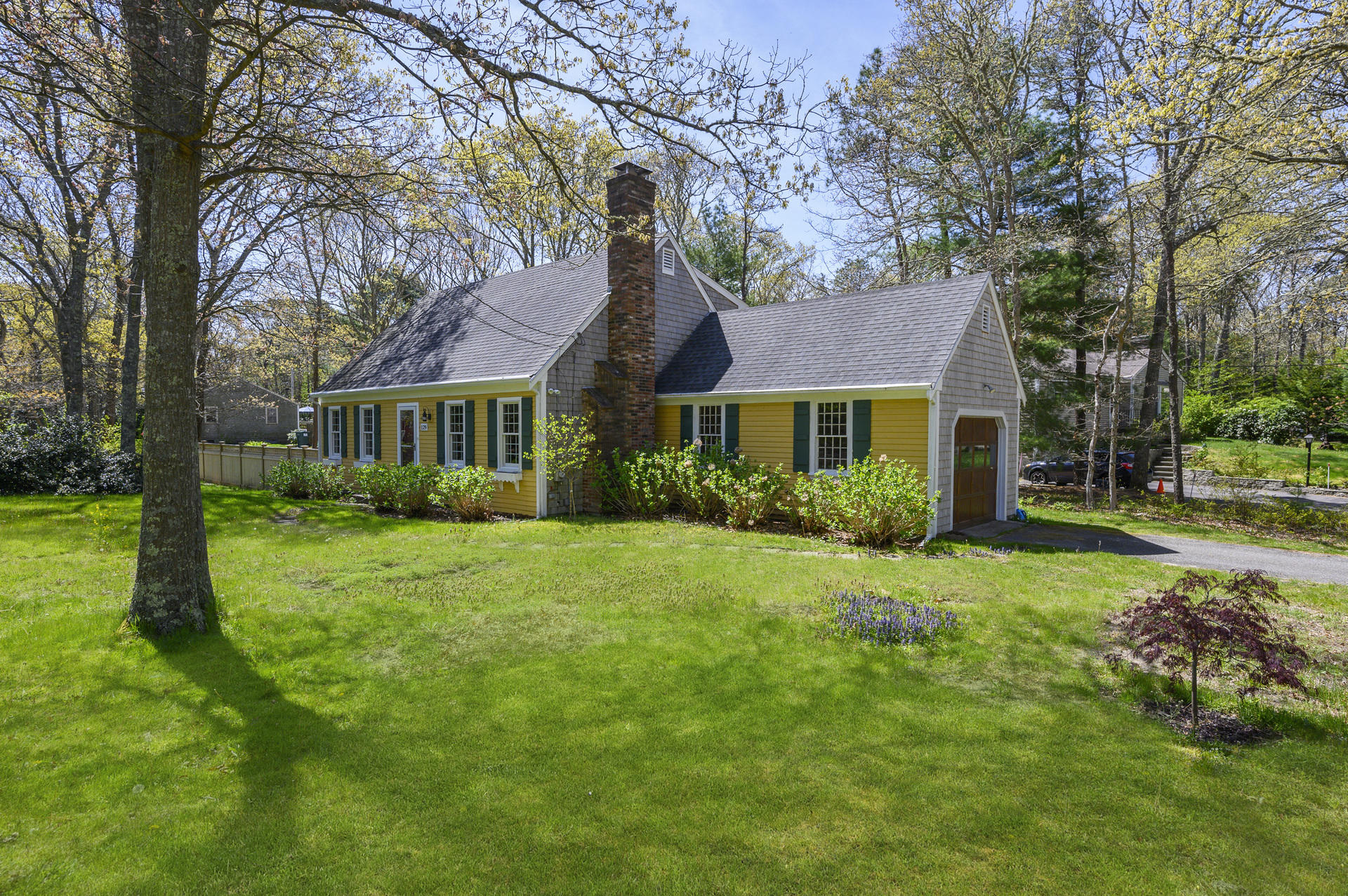 129 Richardson Road Centerville, MA 02632 - Photo 2 of 24 a front view of a house with a garden