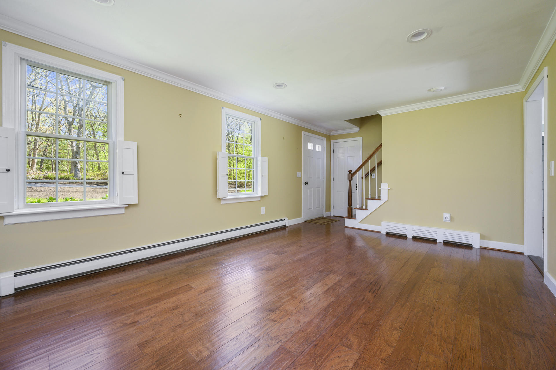 129 Richardson Road Centerville, MA 02632 - Photo 3 of 24 a view of an empty room with wooden floor and a window