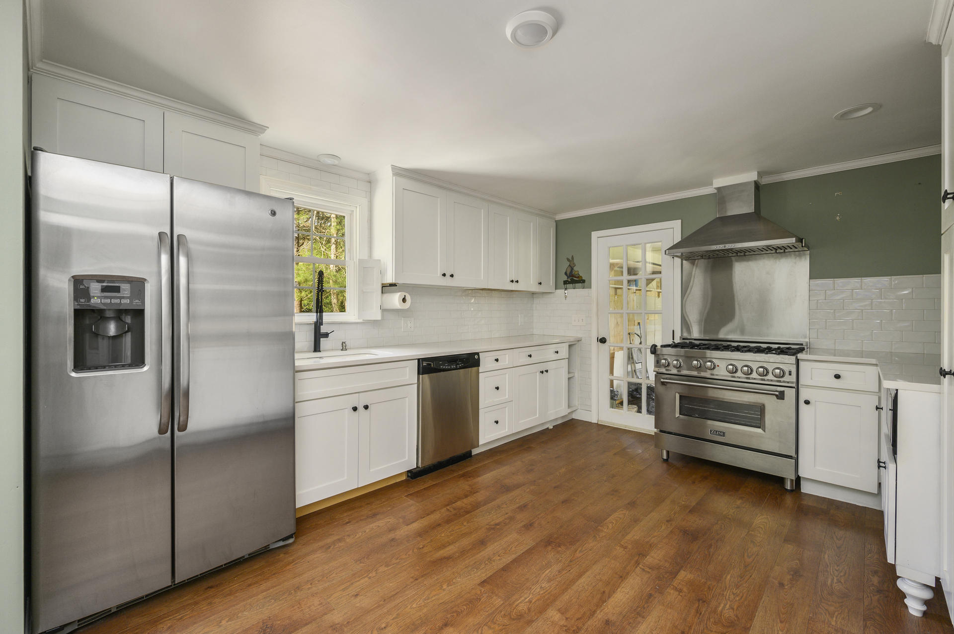 129 Richardson Road Centerville, MA 02632 - Photo 7 of 24 a kitchen with white cabinets and stainless steel appliances