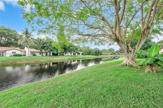 a view of a lake with a house in background