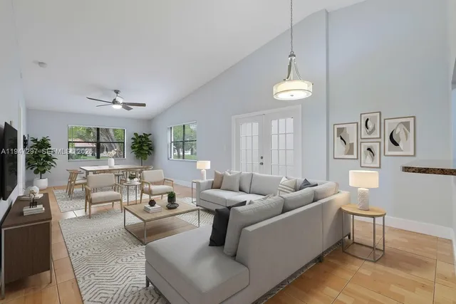 a living room with furniture and a chandelier