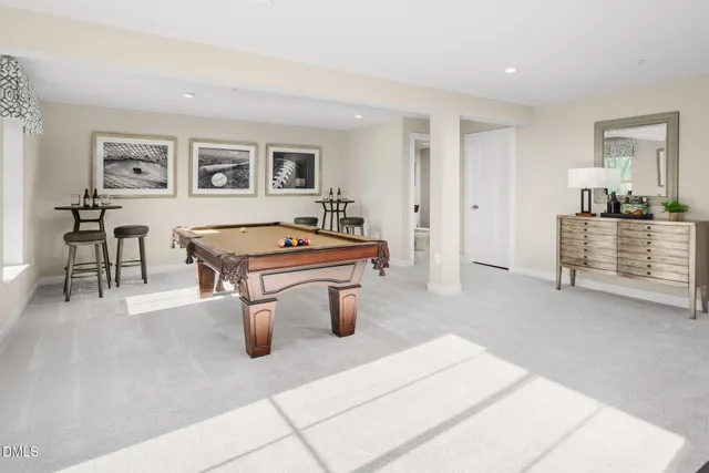 a room with pool table and windows