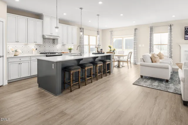 a large kitchen with a table and chairs