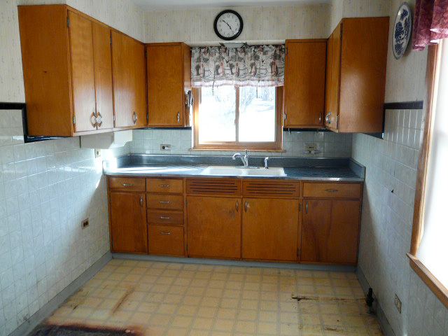 8 Cross Street Fox Lake, IL 60020 - Photo 5 of 10 a kitchen with cabinets a window and stainless steel appliances