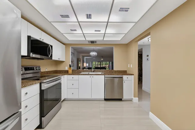 a large kitchen with a stove and a sink