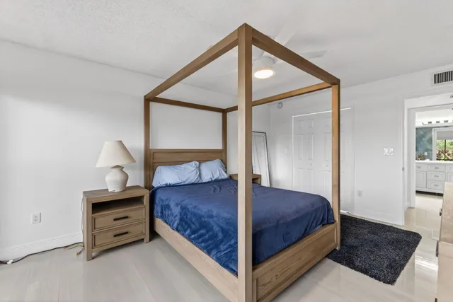 a bedroom with a bed and a night stand