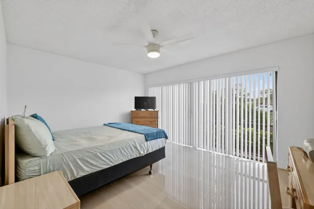 a bedroom with a bed and a night stand