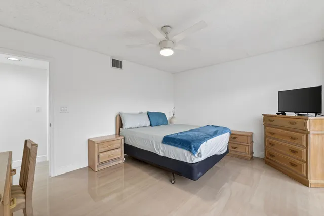 a bedroom with a bed and a television