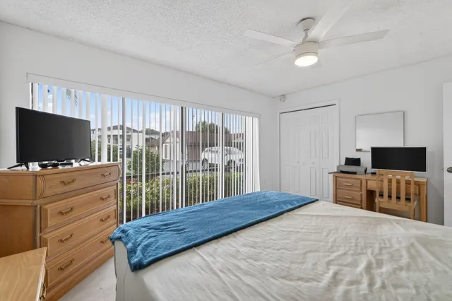 a bedroom with furniture and flat screen tv