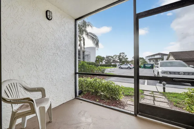 a view of a balcony with chair and table
