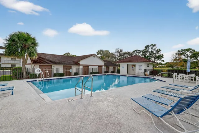 an aerial view of a house with a garden and lake view