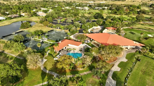 an aerial view of a house with a yard and trees