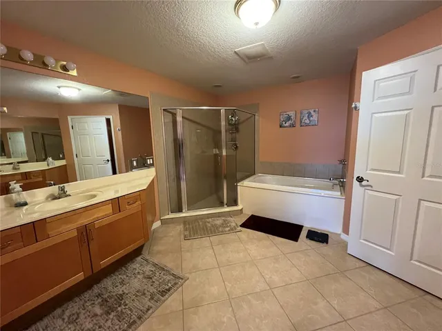 a bathroom with a tub sink and mirror