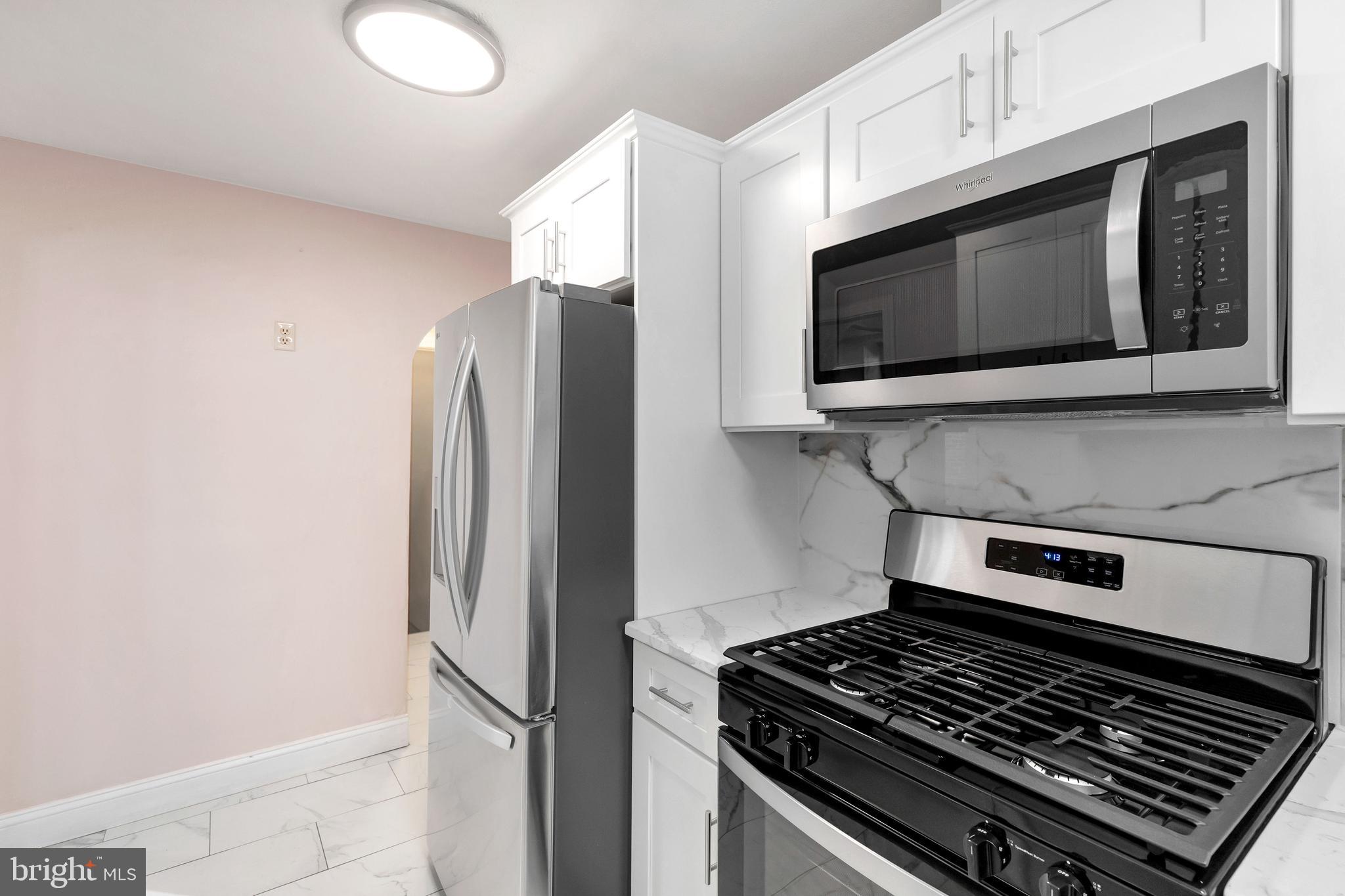 198 Sherbrook Boulevard Upper Darby, PA 19082 - Photo 13 of 30 a kitchen with stainless steel appliances a refrigerator stove and microwave