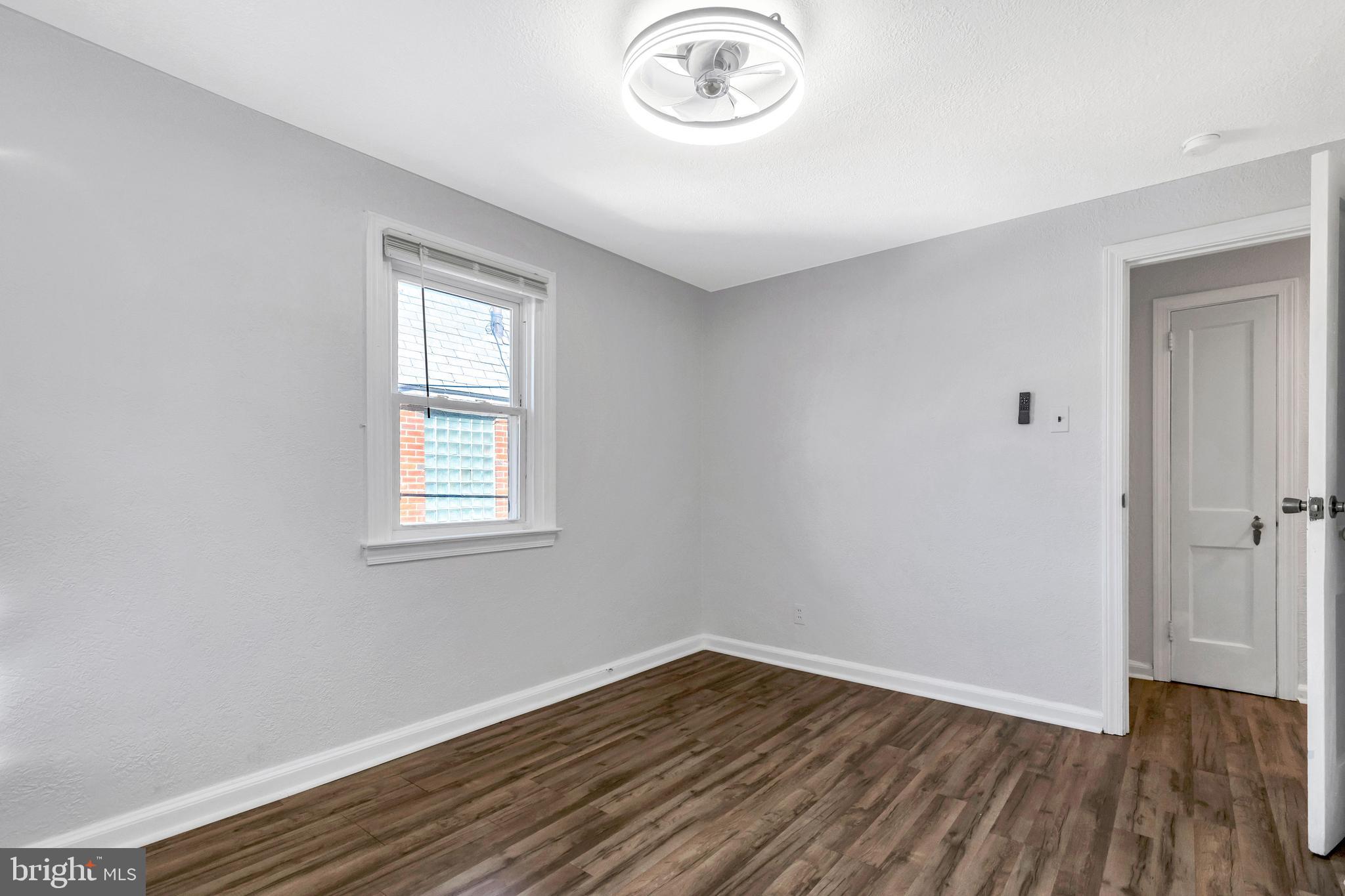 198 Sherbrook Boulevard Upper Darby, PA 19082 - Photo 18 of 30 an empty room with wooden floor and a window