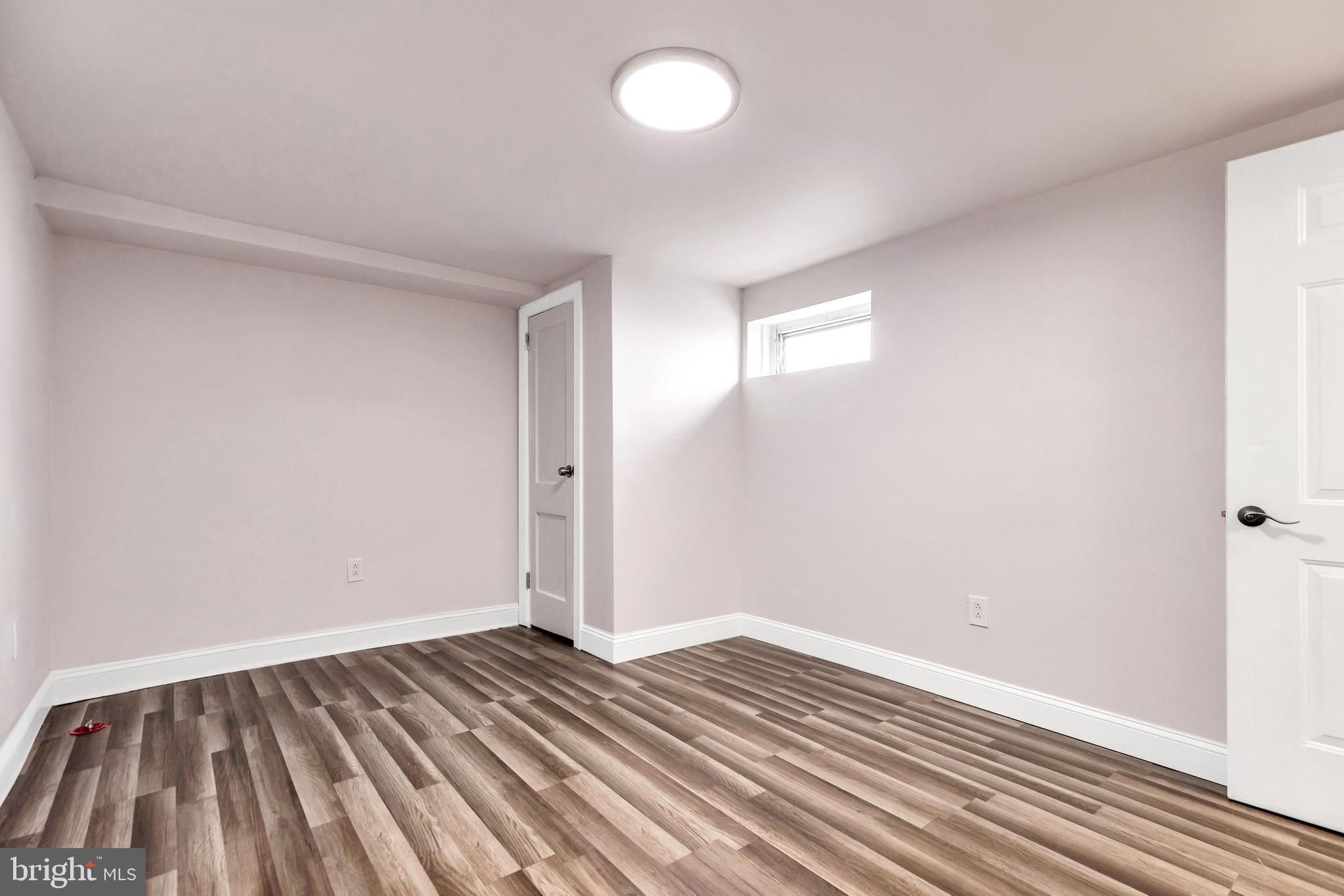 198 Sherbrook Boulevard Upper Darby, PA 19082 - Photo 28 of 30 an empty room with wooden floor and windows