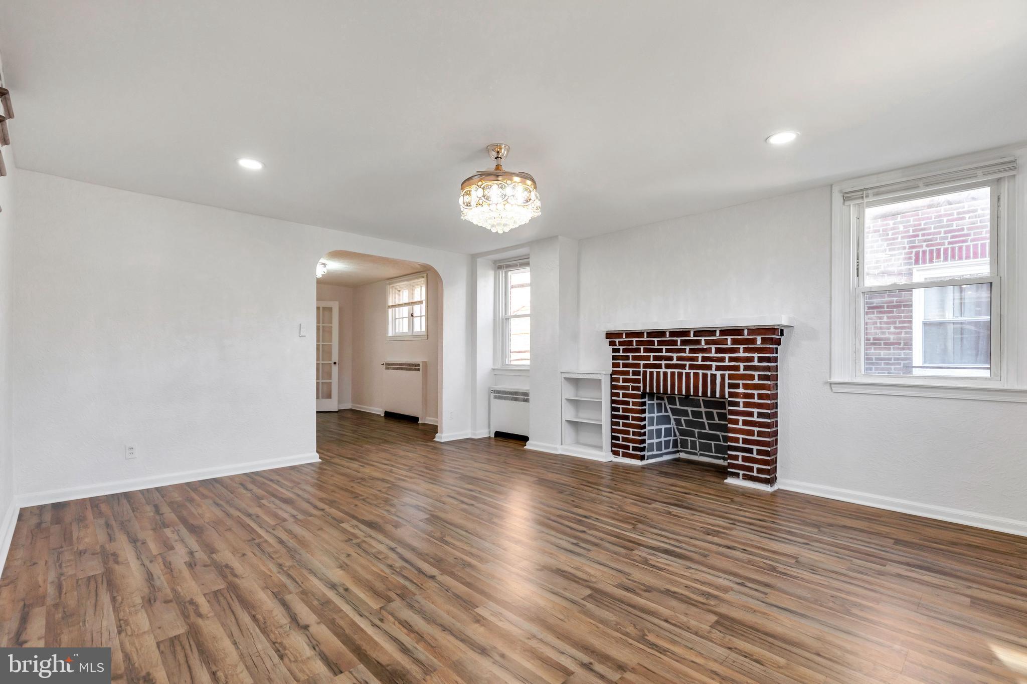 198 Sherbrook Boulevard Upper Darby, PA 19082 - Photo 4 of 30 an empty room with wooden floor and windows