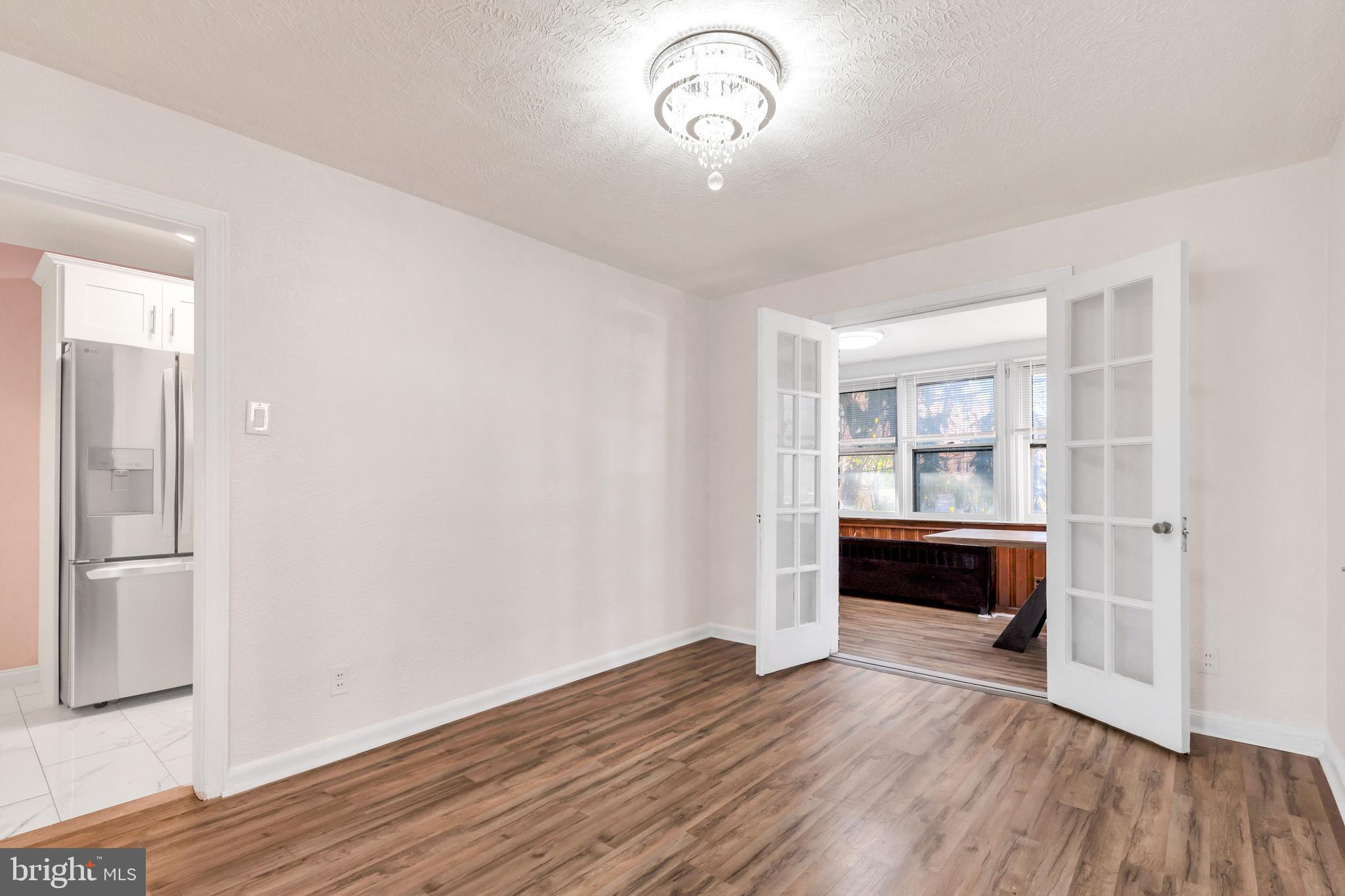 198 Sherbrook Boulevard Upper Darby, PA 19082 - Photo 7 of 30 an empty room with wooden floor and windows