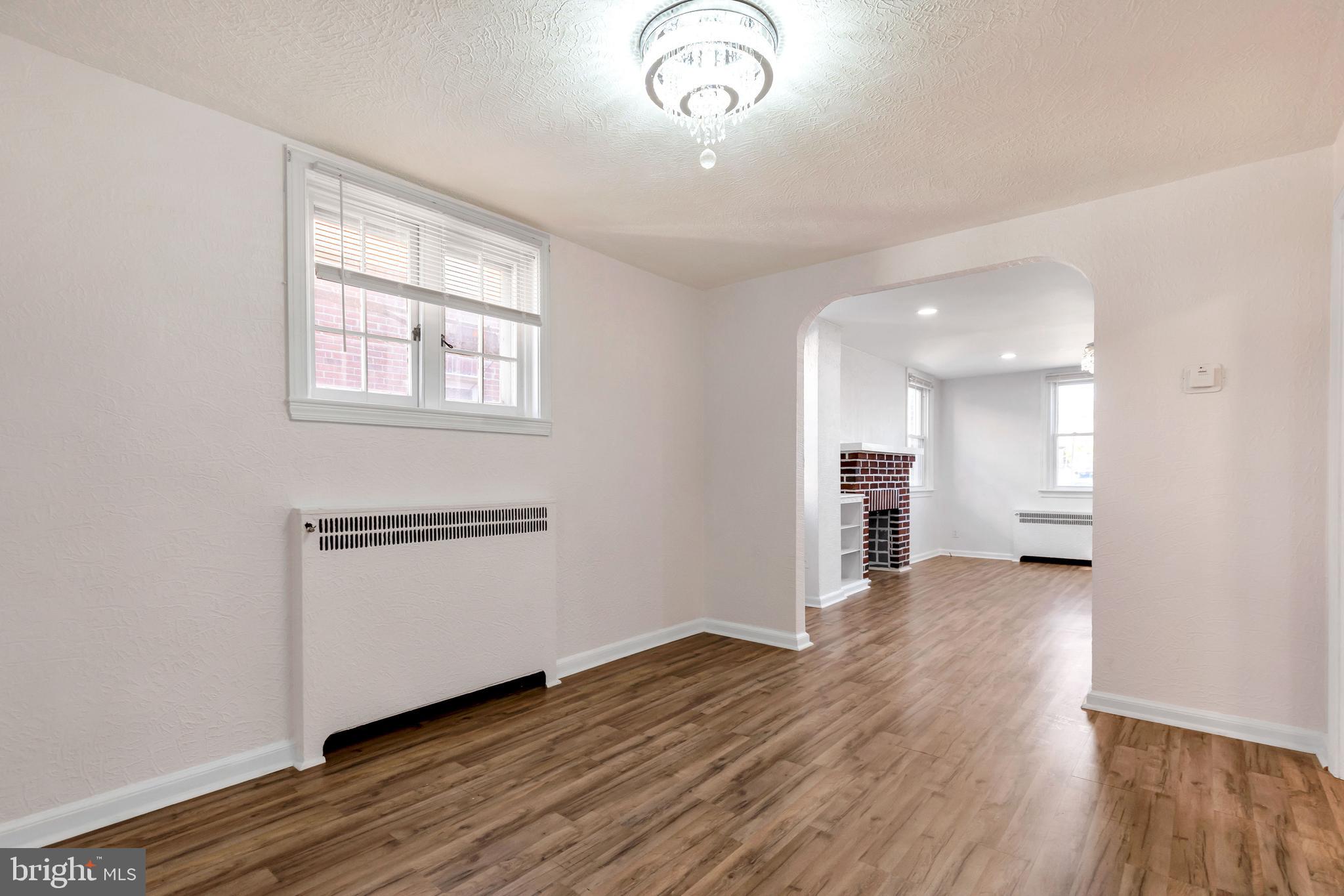 198 Sherbrook Boulevard Upper Darby, PA 19082 - Photo 8 of 30 an empty room with wooden floor cabinet and windows