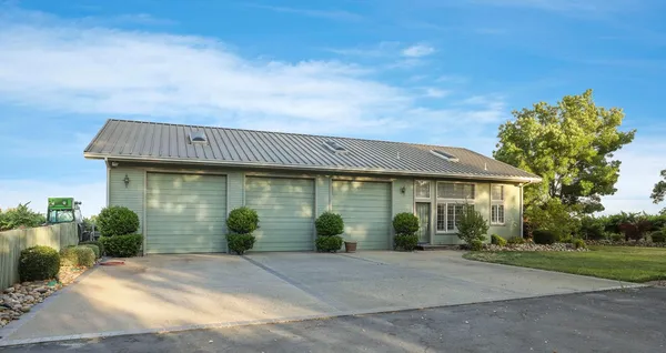 a front view of house with yard and green space