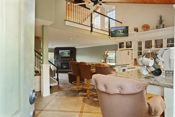 a living room with furniture and kitchen view