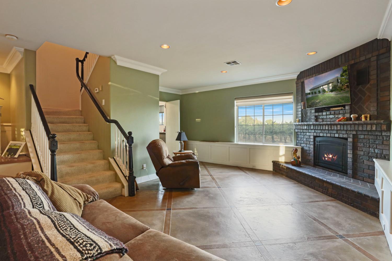 18050 North Tretheway Road Lodi, CA 95240 - Photo 26 of 37 a living room with furniture and a flat screen tv