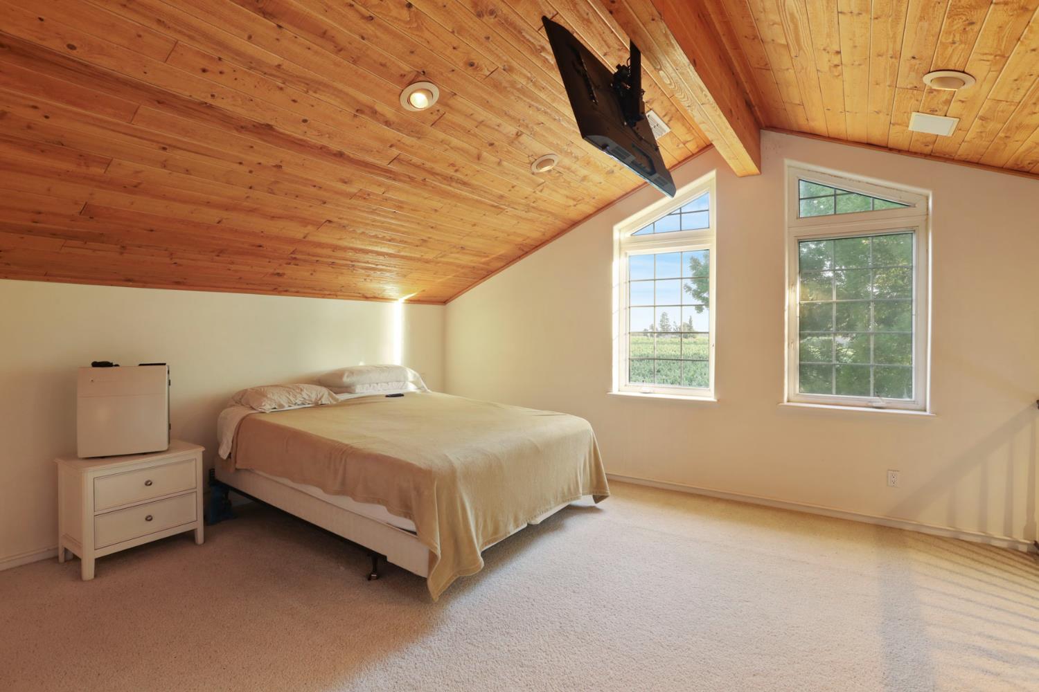18050 North Tretheway Road Lodi, CA 95240 - Photo 30 of 37 a spacious bedroom with a bed and a window