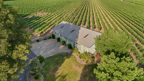an aerial view of a house with a yard