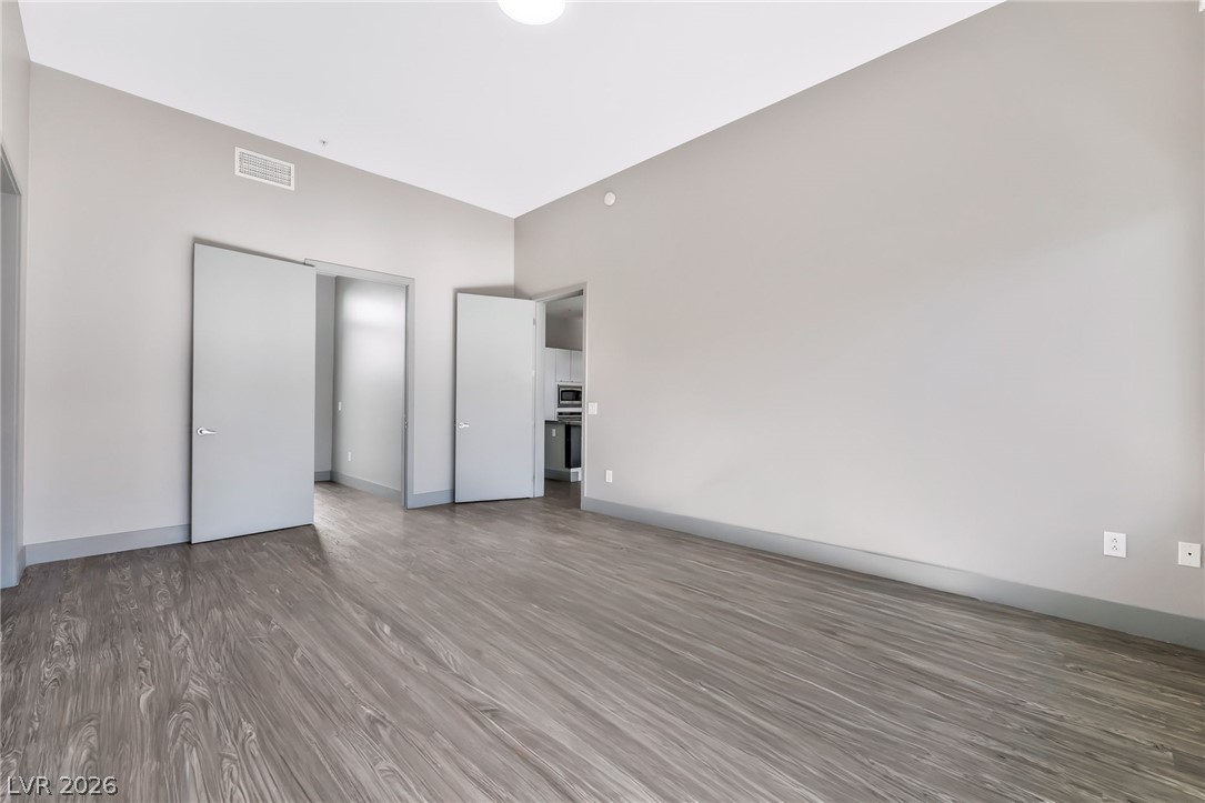 2775 West Pebble Road, Unit 505 Las Vegas, NV 89123 - Photo 10 of 26 Clean lines and wood-look flooring define this inviting, open concept living area.