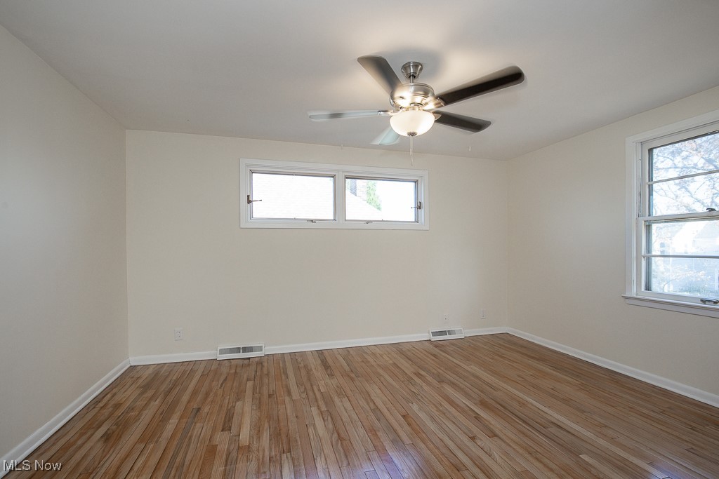 3136 Becket Road Cleveland, OH 44120 - Photo 26 of 39 Empty room with wood-type flooring and ceiling fan