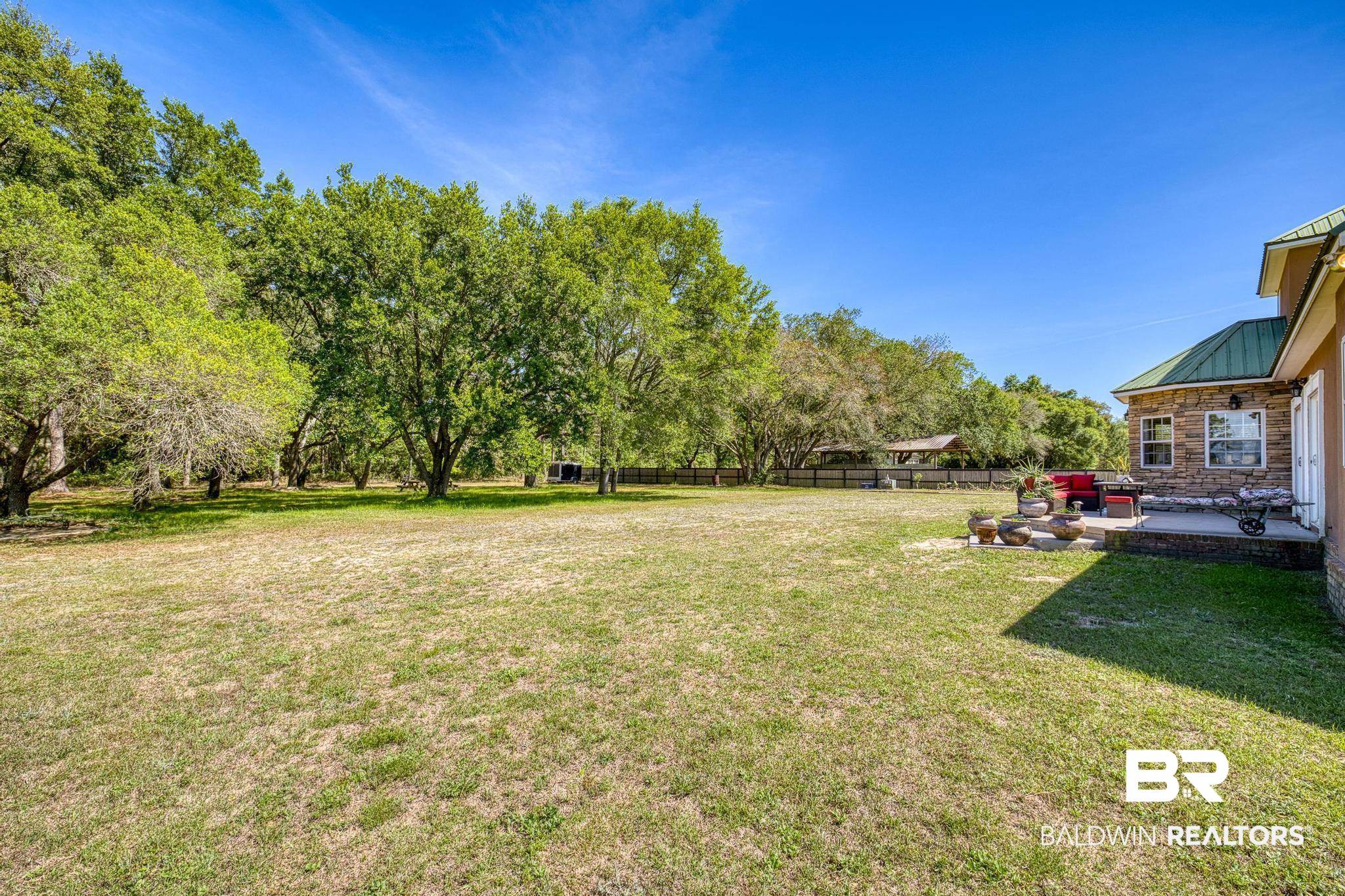 32875 Faircloth Road Lillian, AL 36549 - Photo 67 of 85 Fenced yard with a patio and view of wooded area