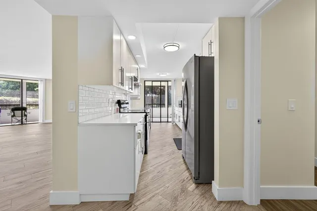 a kitchen with a stove a sink and a refrigerator
