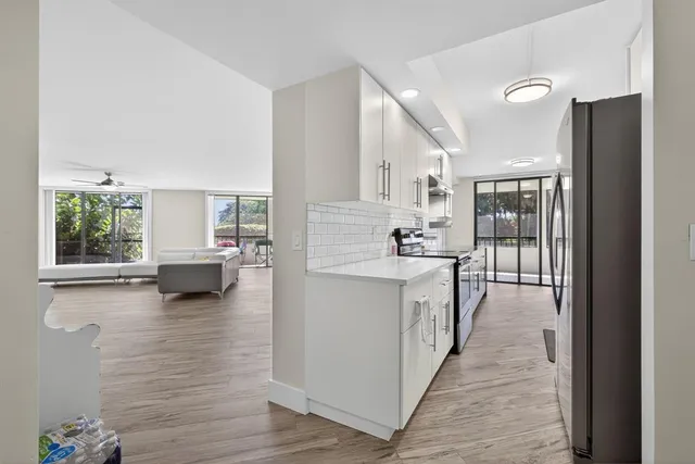 a kitchen with a sink refrigerator and cabinets
