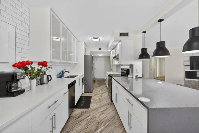 a open kitchen with wooden floor and window
