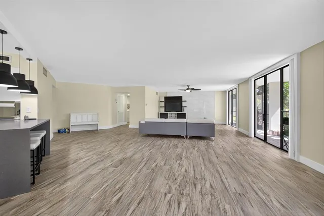 a bedroom with a bed wooden floor and a window