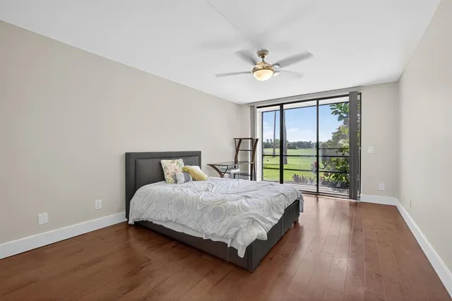 a spacious bedroom with a bed and a ceiling fan