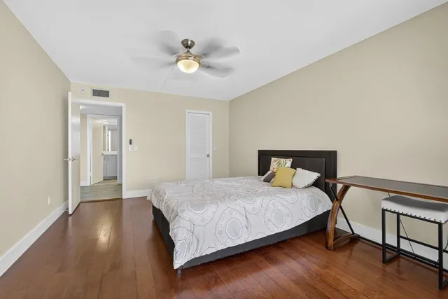 a bathroom with a granite countertop sink a toilet and a mirror