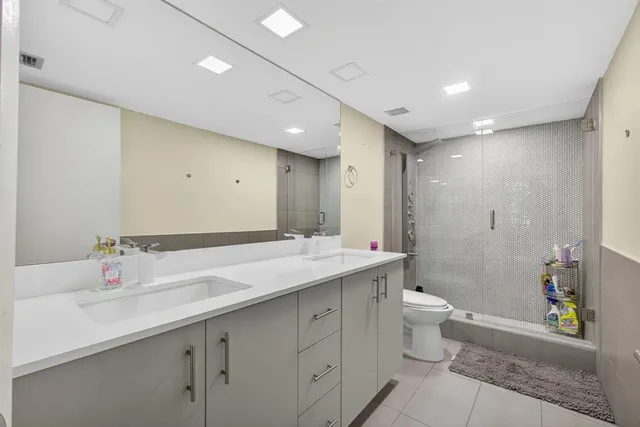 a balcony with chairs and with potted plants