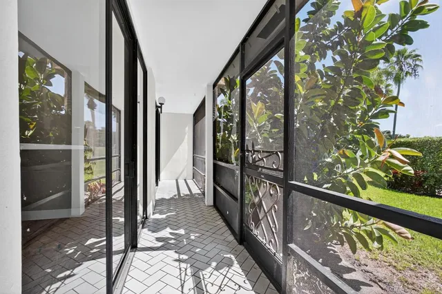 a view of an empty room with wooden floor and closet