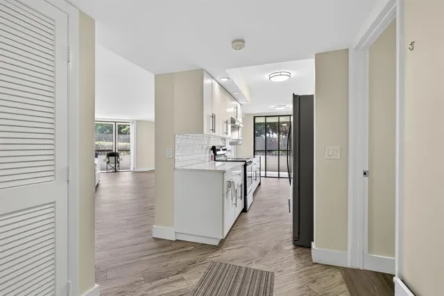 a large white kitchen with a stove a sink and dishwasher