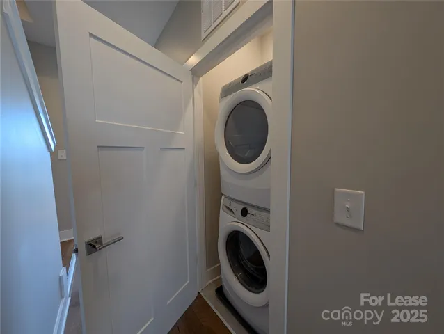a view of a room with wooden floor and windows
