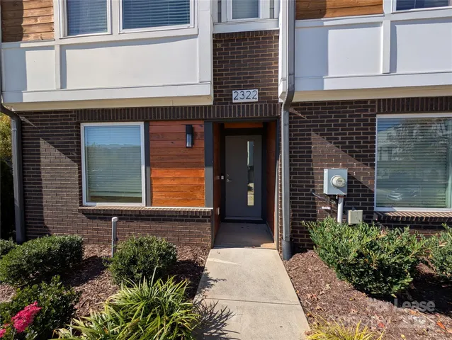 front view of a brick house with a small window