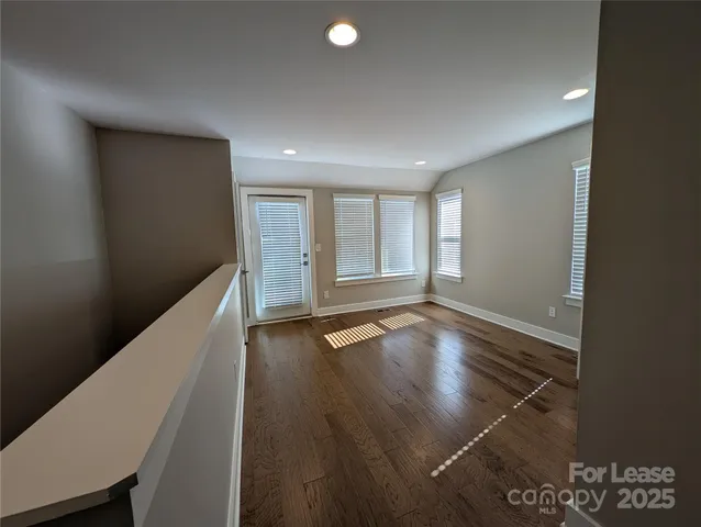 a view of a hallway with seating space