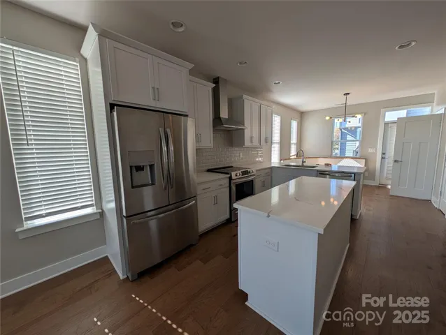a kitchen with a refrigerator and a sink